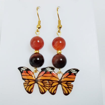 Bijou en Cornaline et Œil de Taureau pour la vitalité et l'ancrage. Profitez d'une protection puissante avec ce bijou papillon. Découvrez la collection !